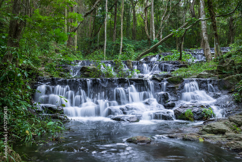Samlan Waterfall, tier 3, tropical waterfall cascading through lush jungle in Thailand's natural forest reserve.
