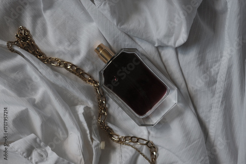 perfume bottle with brown liquid on a white background	
