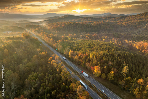 USA highway transportation infrastructure in North Carolina Appalachian mountains. American freeway road with fast driving semi trucks