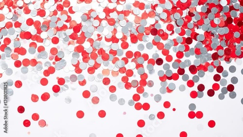 Scattered red and silver confetti circles on a bright white surface, suggesting celebration and festivity