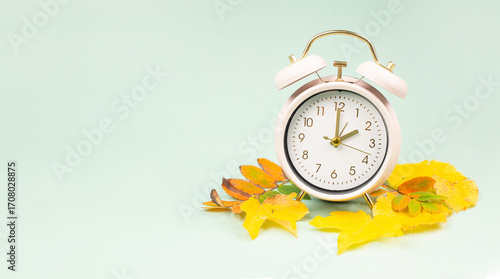 Winter time changeover, end of daylight saving time in autumn, alarm clock fall back switch, colorful foliage, change season