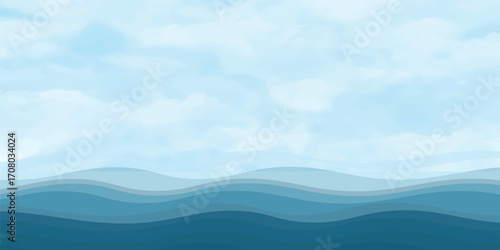 Blue sea waves with a misty mountain landscape at sunrise and a sky full of clouds