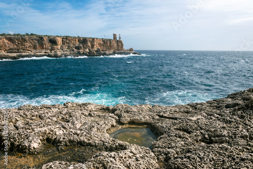 Cliffs of Cala de Figuera with waves in the sea