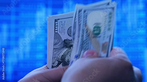 Hands counting dollars on a rising stock market chart, symbolizing money, investment, profit, financial growth, trading, currency, business success, and economic development.