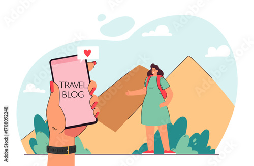 Hand of woman holding phone with travel blog on screen