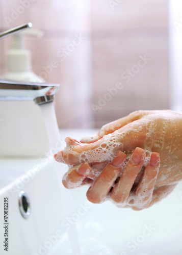 Wallpaper Mural girl washes her hands with soap, hygiene and cleanliness of hands. Vertical photo format Torontodigital.ca