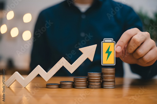 Wooden Zigzag Arrow with Ascending Coin Stacks and Battery Icon – Financial Growth