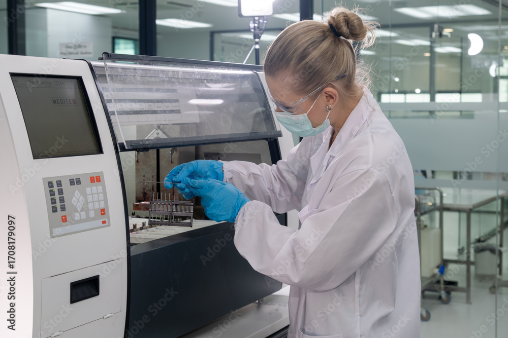 Naklejka premium Scientist operates laboratory equipment while conducting research in a modern lab setting