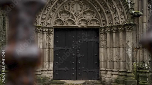 Wallpaper Mural Intricately carved stone archway highlights a medieval church door, ideal for historical or architectural themed designs and concepts. Torontodigital.ca