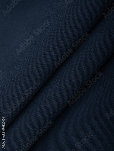 Dark dense fabric for sewing clothes, ironed, the texture of the fabric is visible