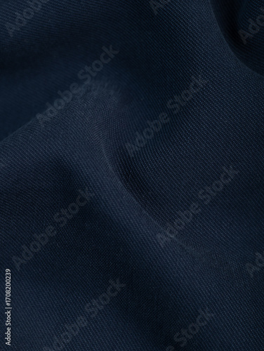Dark dense fabric for sewing clothes, ironed, the texture of the fabric is visible