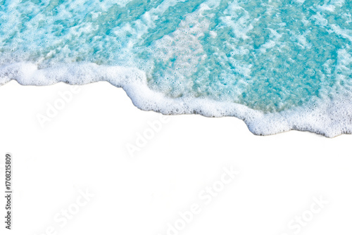 Gentle wave with white foam meets shore, creating serene and calming scene