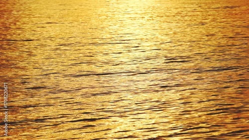 Gold sunset or sunrise water reflection waves texture nature background