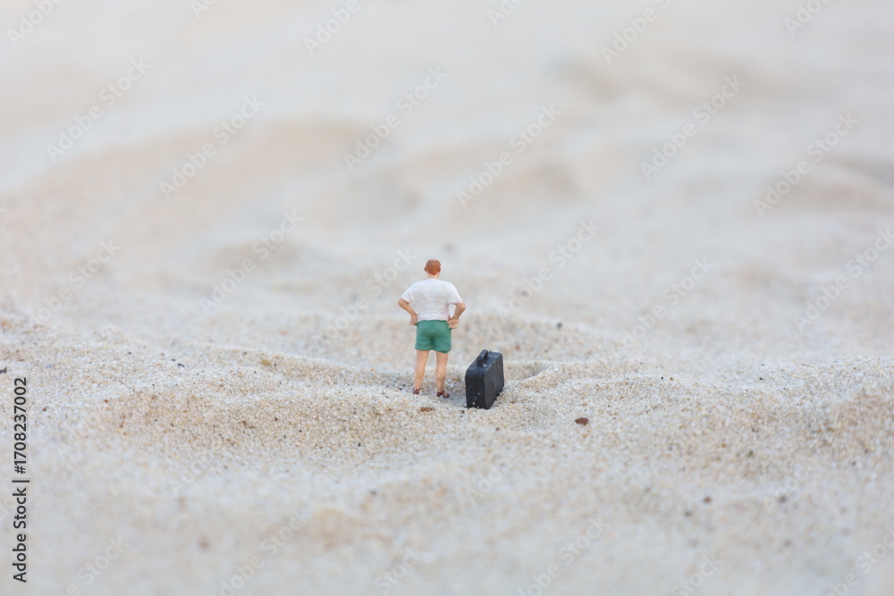 Naklejka premium Minimalist Tiny Man with Luggage Contemplating Beach Landscape Scenery