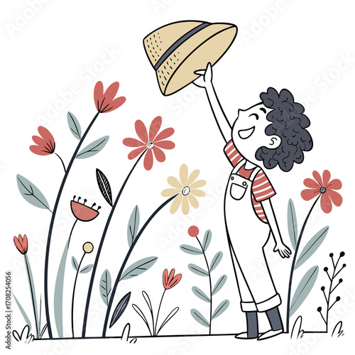 Joyful child in overalls holding up a straw hat amidst a field of colorful wildflowers