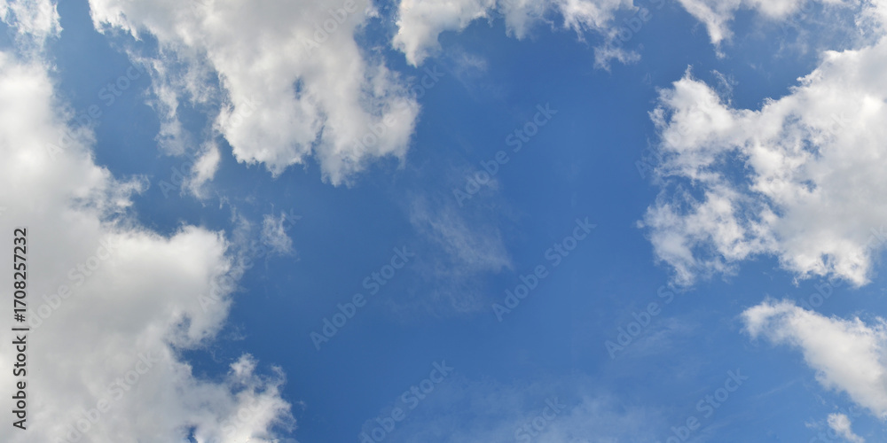 Obraz premium Bright blue sky background with frame of white fluffy clouds .Nature horizontal sky landscape,sunny weather, natural environment.