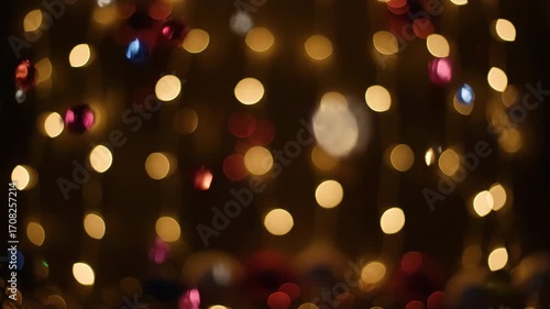 A captivating seamlessly looping video featuring shimmering bokeh lights dancing and blurring against a dark, festive backdrop smooth, magic, gentle