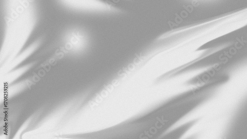 Soft natural light and shadow patterns of palm leaves creating a serene and organic background texture