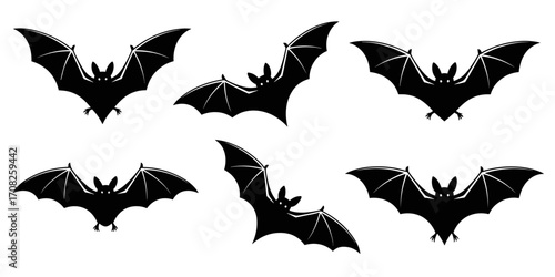 Vector illustration of bats in flying positions in silhouette style
