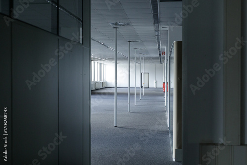 Fototapeta Naklejka Na Ścianę i Meble -  Modern empty office space with grey carpet, white walls, and bright windows. Ideal for commercial real estate.