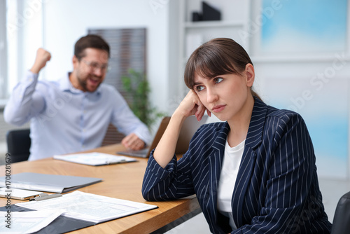 Obraz na plátně Woman feeling jealous of her colleague's success in office, selective focus