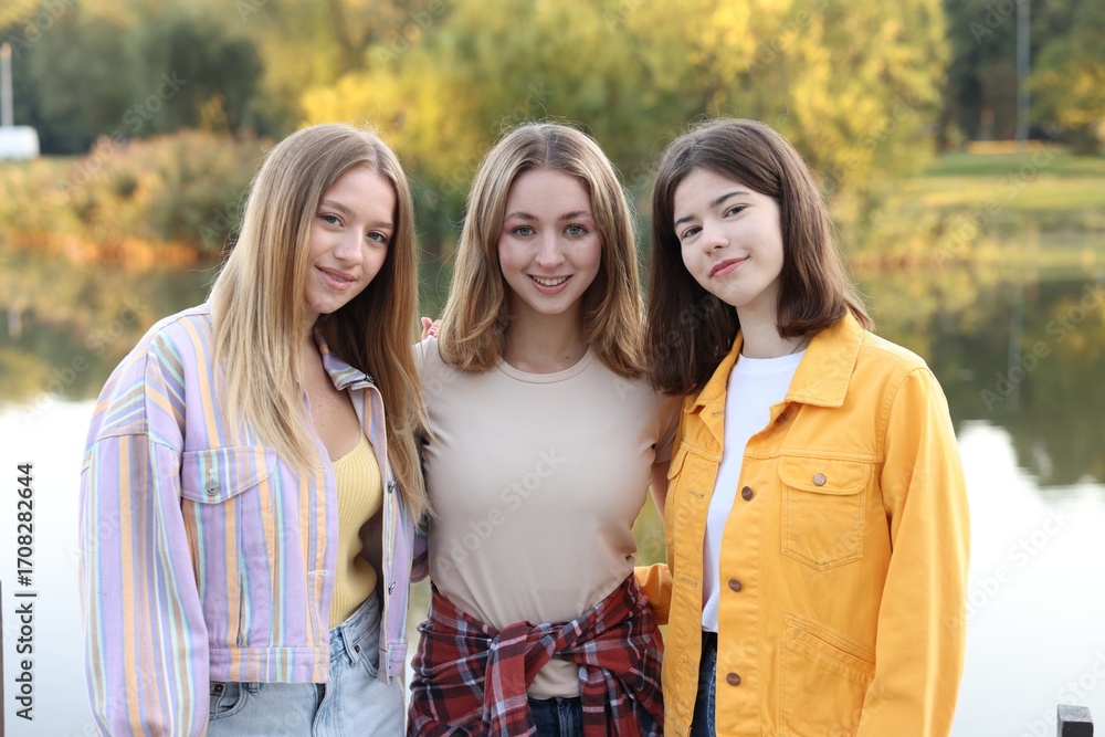 Fototapeta premium Portrait of teenage girls near lake outdoors