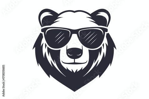 A cool bear is staring out with his black sunglasses on his furry face