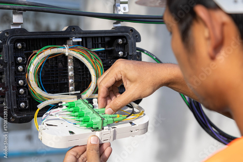 Fotografie Engineer or technician checking fiber optic cables in internet splitter box