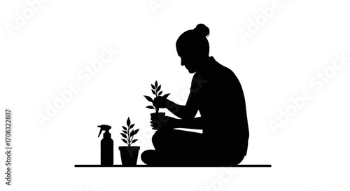 Person tending to small plants with spray bottle, cultivating growth and nature indoors