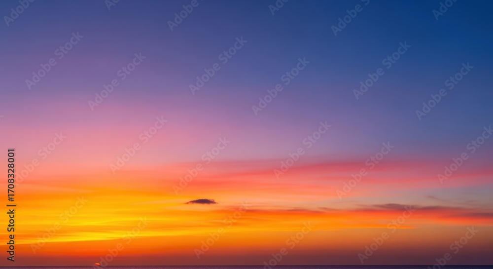 Fototapeta premium Breathtaking Sunset Over Calm Ocean with Vibrant Colors and Cloudy Sky at Dusk