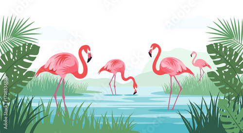 Flamingos wading in shallow water surrounded by lush green tropical foliage.