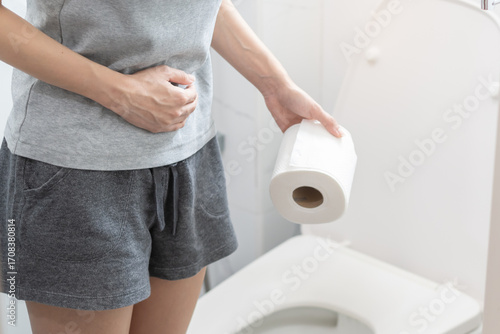 Photos Woman holding toilet paper go to toilet.
