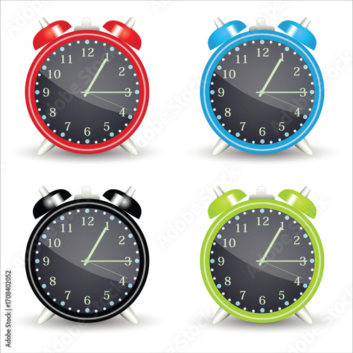 Set of four colorful classic twin bell alarm clocks.
