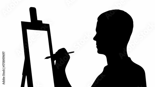Silhouette of artist painting on canvas at easel in black and white creating artwork in studio space