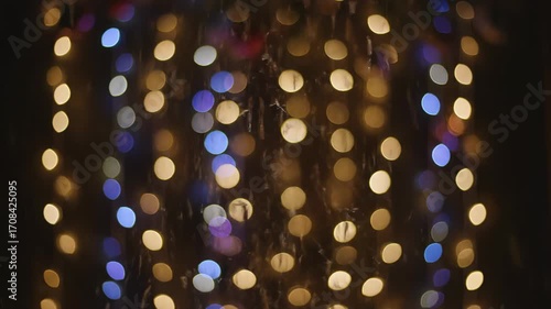 A captivating seamlessly looping video featuring shimmering bokeh lights dancing and blurring against a dark, festive backdrop pattern, backdrop, lights