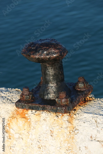 rusty bollard on the concrete pier
