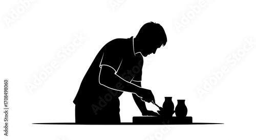Focused artisan shapes clay on pottery wheel creating elegant vessels with meticulous craftsmanship