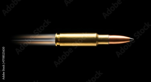 Bullet in motion against black background