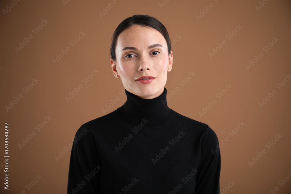 Fototapeta premium Portrait of beautiful woman on brown background