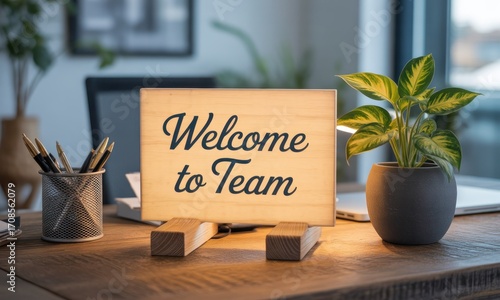 Wooden sign on a desk, illuminated, welcoming new team member