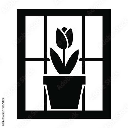 A silhouette of a tulip in a pot viewed through a window pane flower