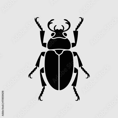 Black silhouette of a scarab beetle on a light gray background