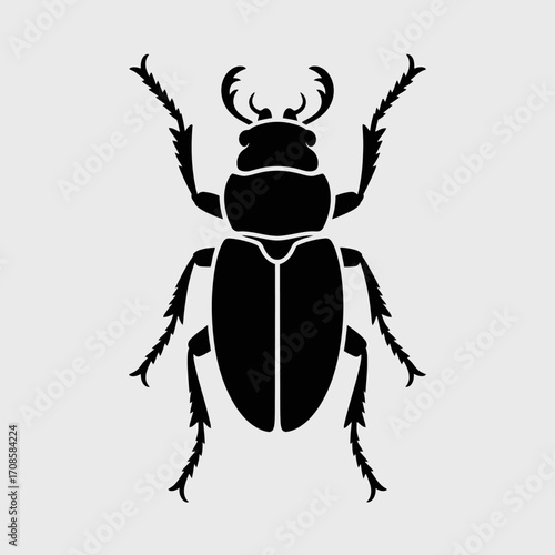 Black silhouette of a stag beetle on a light gray background