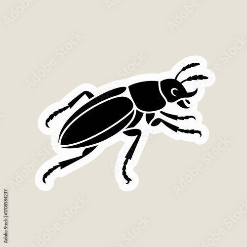 Black silhouette of a stag beetle on a light beige background