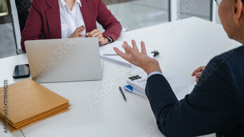 Attorney consulting clients in law firm office with professional discussion