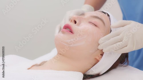 A close-up of a young Asian woman receiving a Botox or dermal filler injection in her face from a professional. Concept for beauty clinics, dermatology, and anti-aging treatments.
