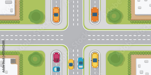 Top view of a busy city intersection with cars and buildings