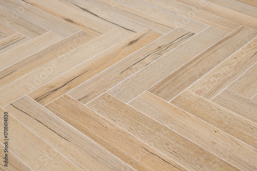 Wood like floor tiles arranged in herringbone pattern