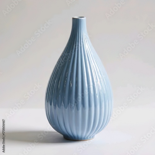Title:
Blue ceramic vase with teardrop shape and vertical grooves