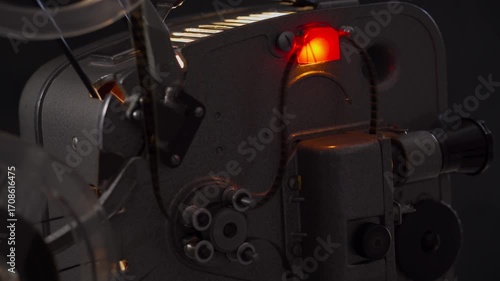 Vintage film projector spinning at high speed creating nostalgic ambiance for cinema enthusiasts.